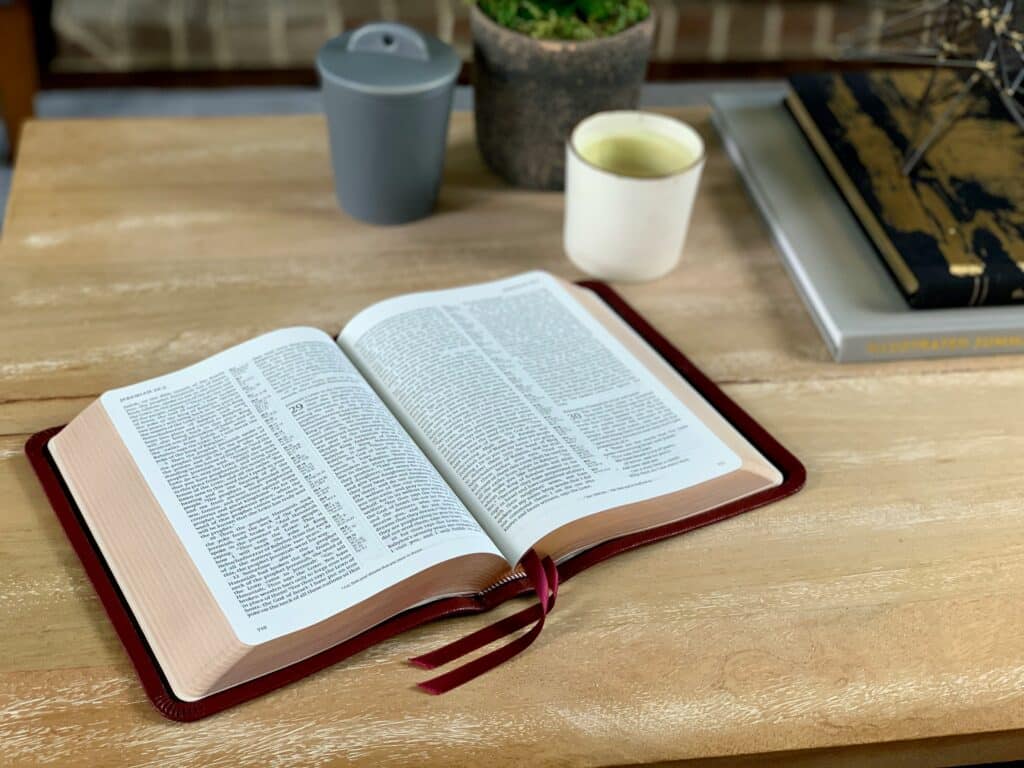 Open Bible on a wooden table symbolizing faith-centered reflection and healing in Christian counseling