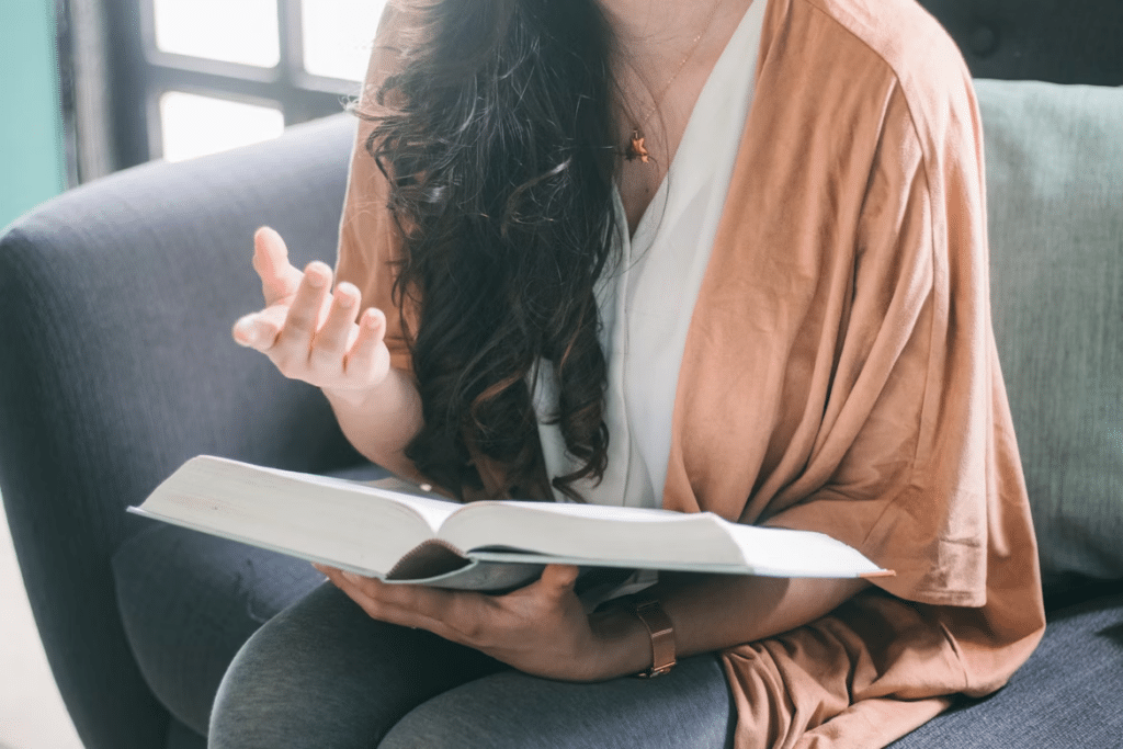 Client seated in a counseling session, reading and reflecting as part of trauma-informed therapy